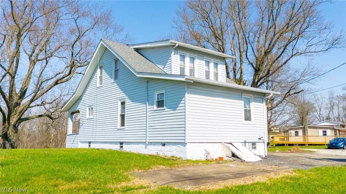 53341 Key Bellaire Road Bellaire, OH 43906 - Photo 45 of 48 View of home's exterior featuring a shingled roof and a lawn