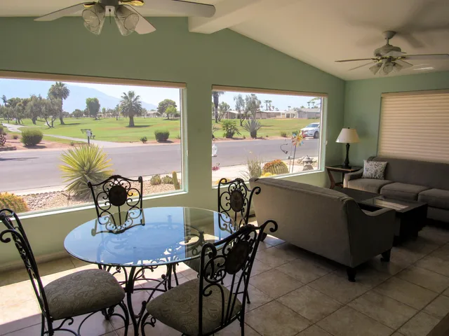 a view of a dining room with furniture window and outside view