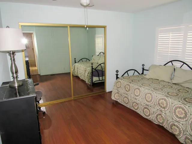 a bedroom with a bed and a dresser