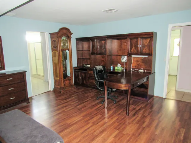 a workspace with furniture window and wooden floor