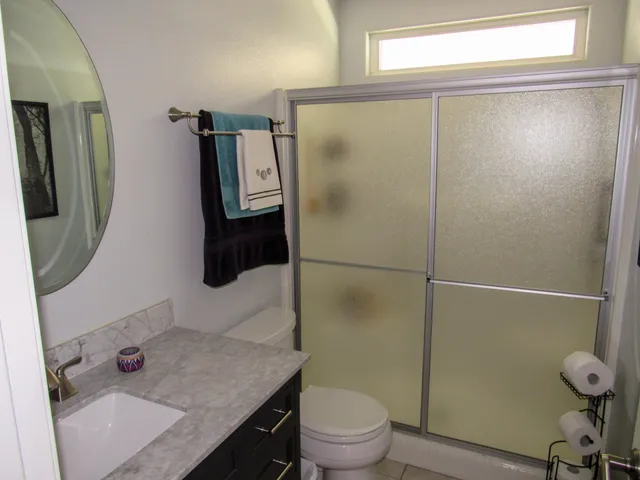 a bathroom with a shower toilet and sink