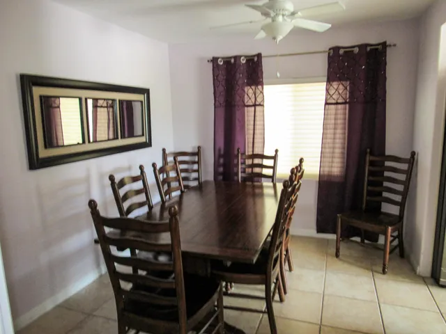 a dining room with furniture and window