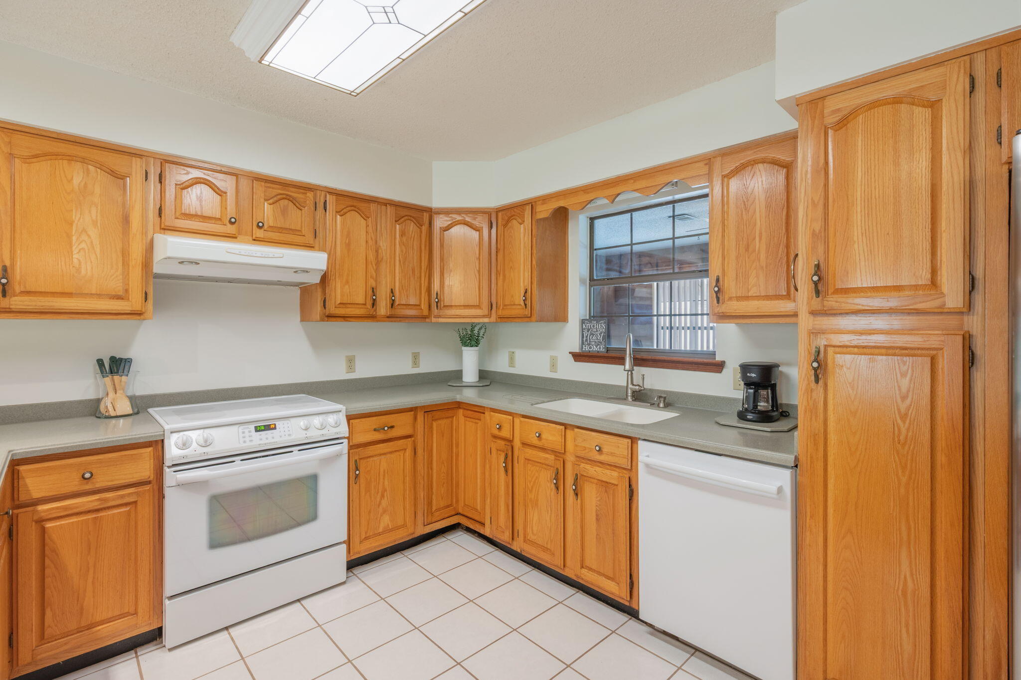 4841 Antioch Road Crestview, FL 32536 - Photo 19 of 70 a kitchen with granite countertop stainless steel appliances white cabinets sink and a dishwasher