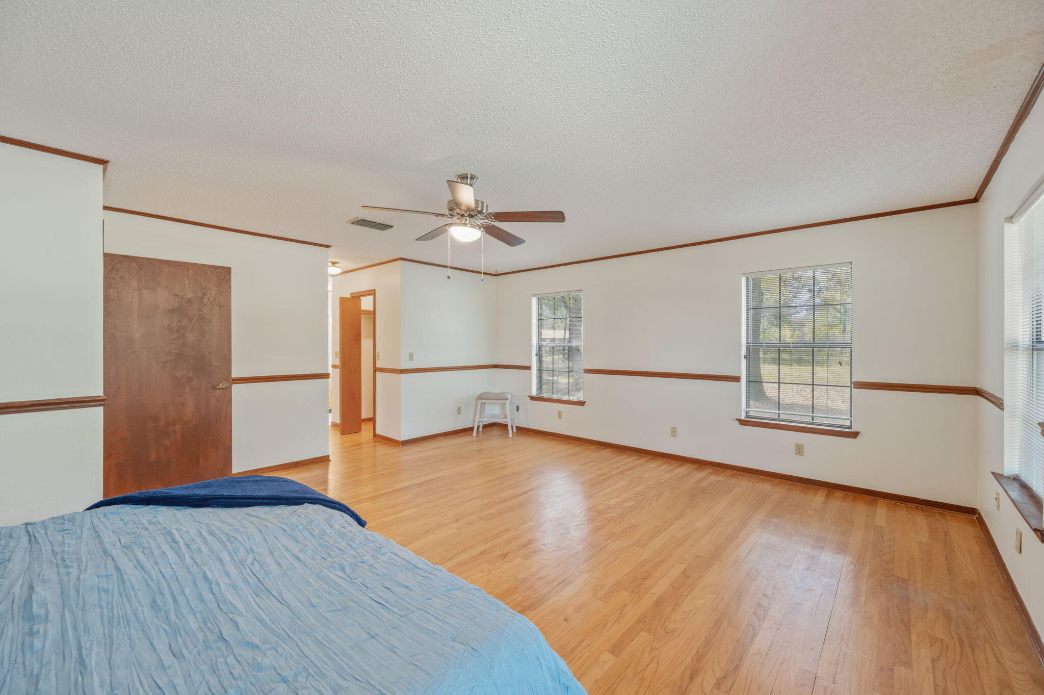 4841 Antioch Road Crestview, FL 32536 - Photo 22 of 70 a view of an empty room with wooden floor and a window