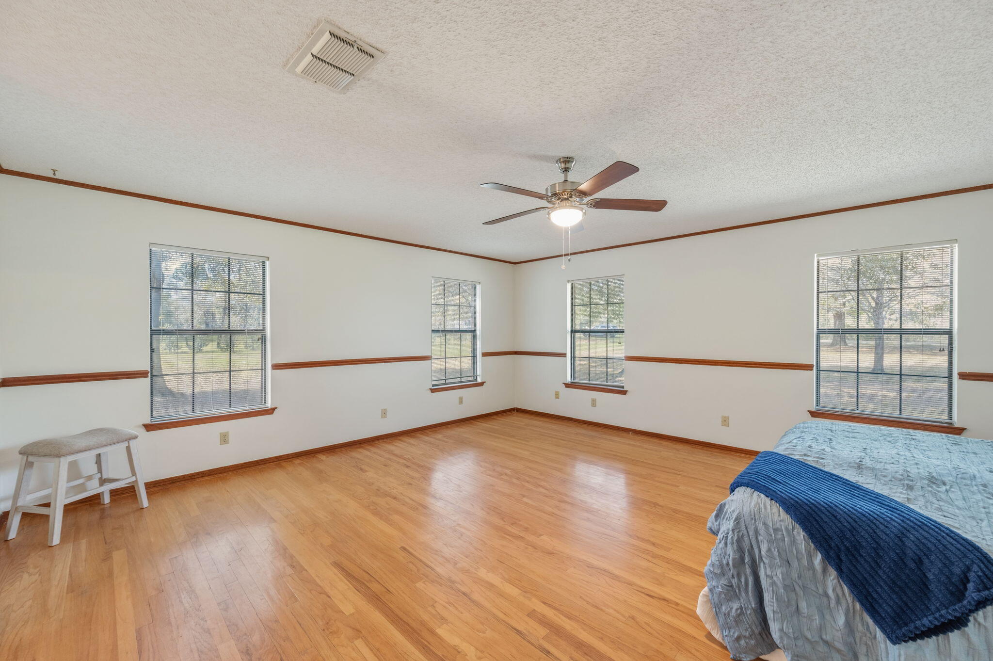 4841 Antioch Road Crestview, FL 32536 - Photo 23 of 70 a view of an empty room with a window and wooden floor