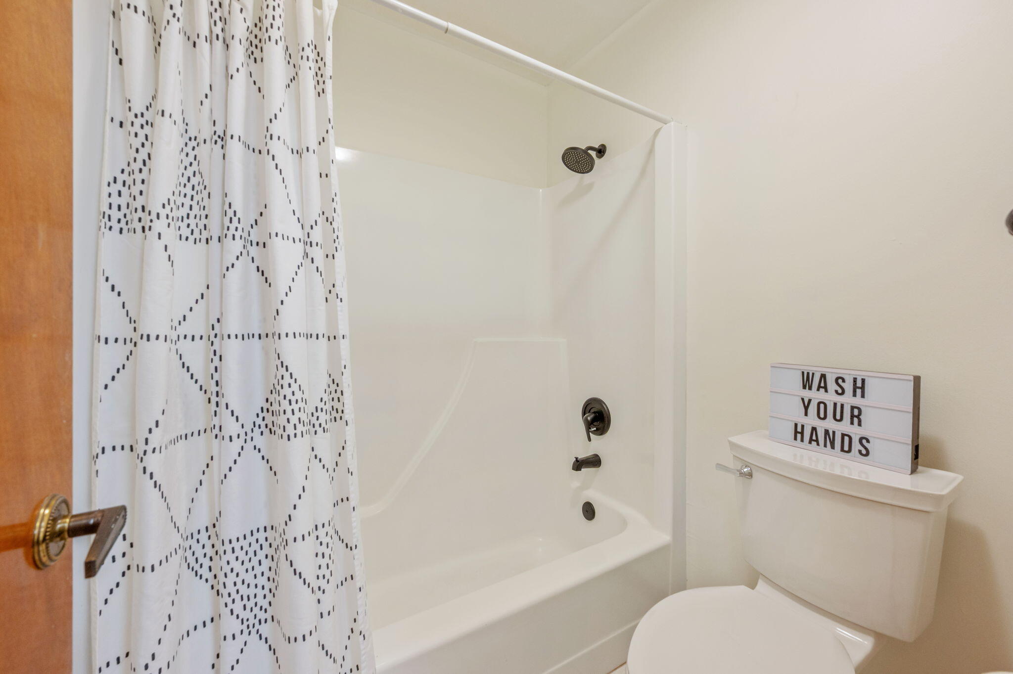 4841 Antioch Road Crestview, FL 32536 - Photo 32 of 70 a white toilet sitting next to a bath tub