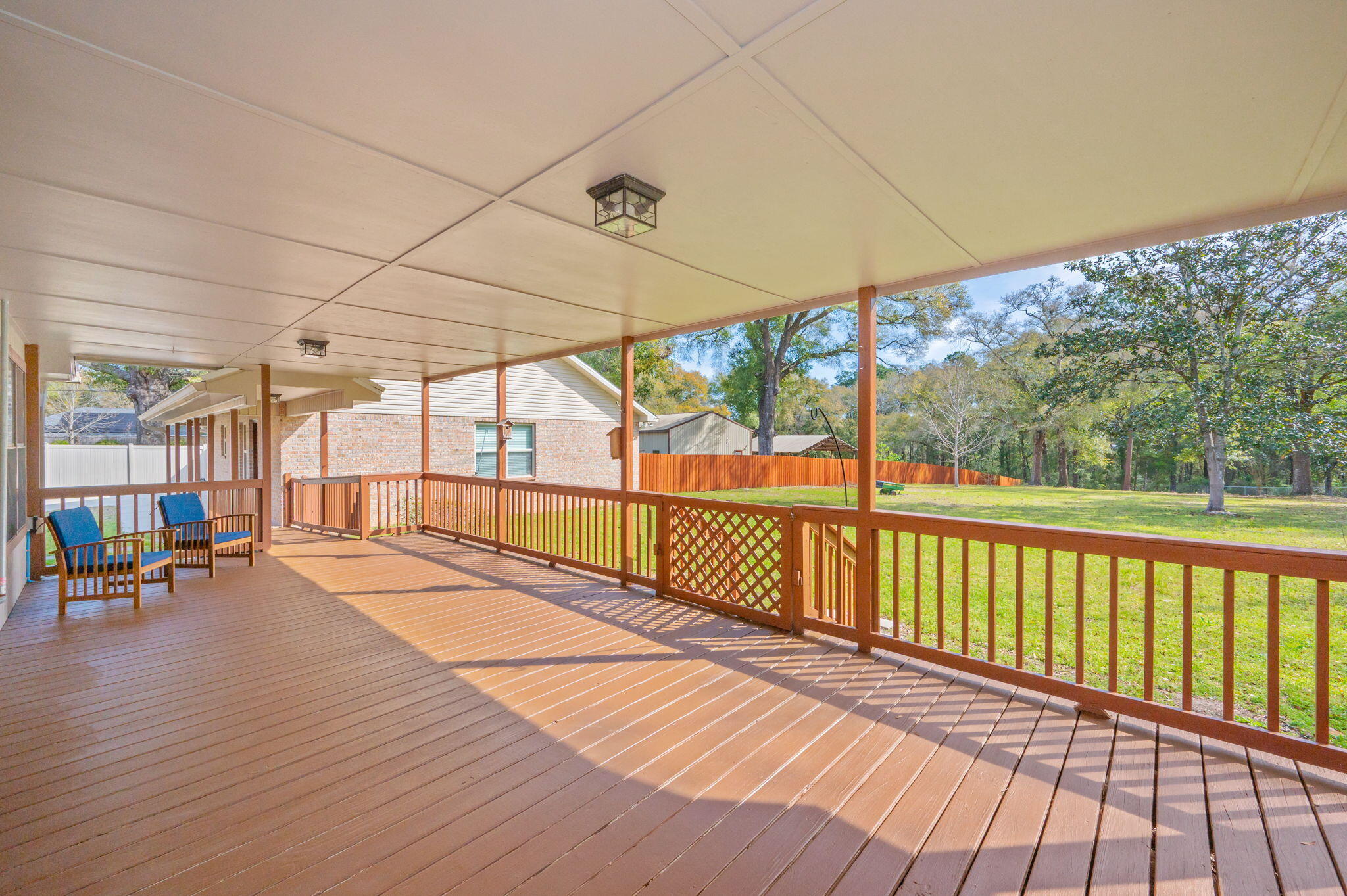 4841 Antioch Road Crestview, FL 32536 - Photo 45 of 70 a view of a balcony with chairs and wooden floor