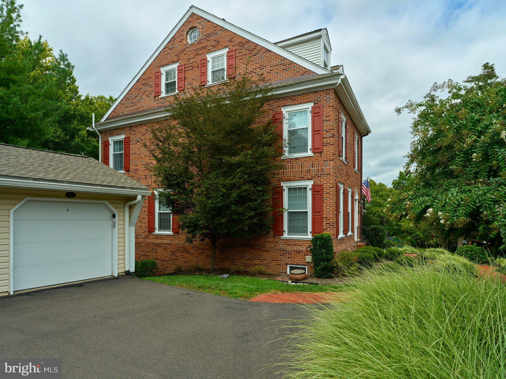 27 Sentinel Road, Unit 139 Washington Crossing, PA 18977 - Photo 36 of 37 Charming brick home with lush greenery.
