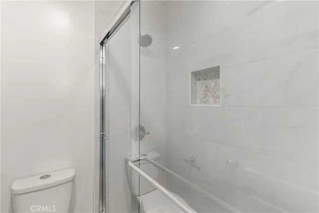 a bathroom with a shower and a toilet