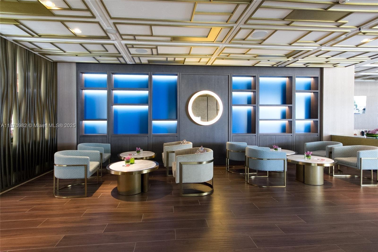 6799 Collins Avenue, Unit 1601 Miami Beach, FL 33141 - Photo 16 of 27 a living room with furniture and wooden floor