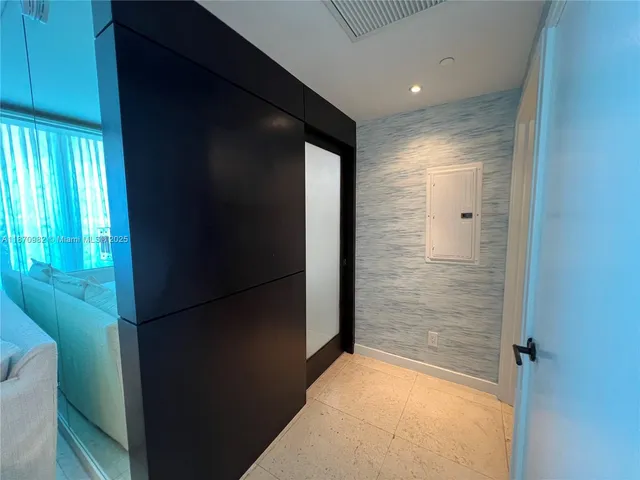 a bathroom with a glass shower door