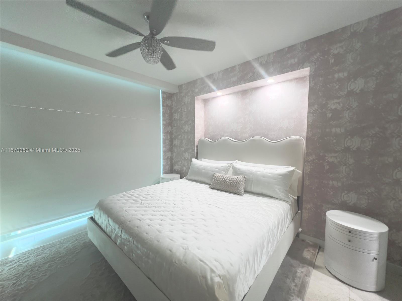 6799 Collins Avenue, Unit 1601 Miami Beach, FL 33141 - Photo 9 of 27 a bedroom with a bed and a window