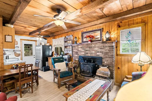a living room with furniture a fireplace and next to a window