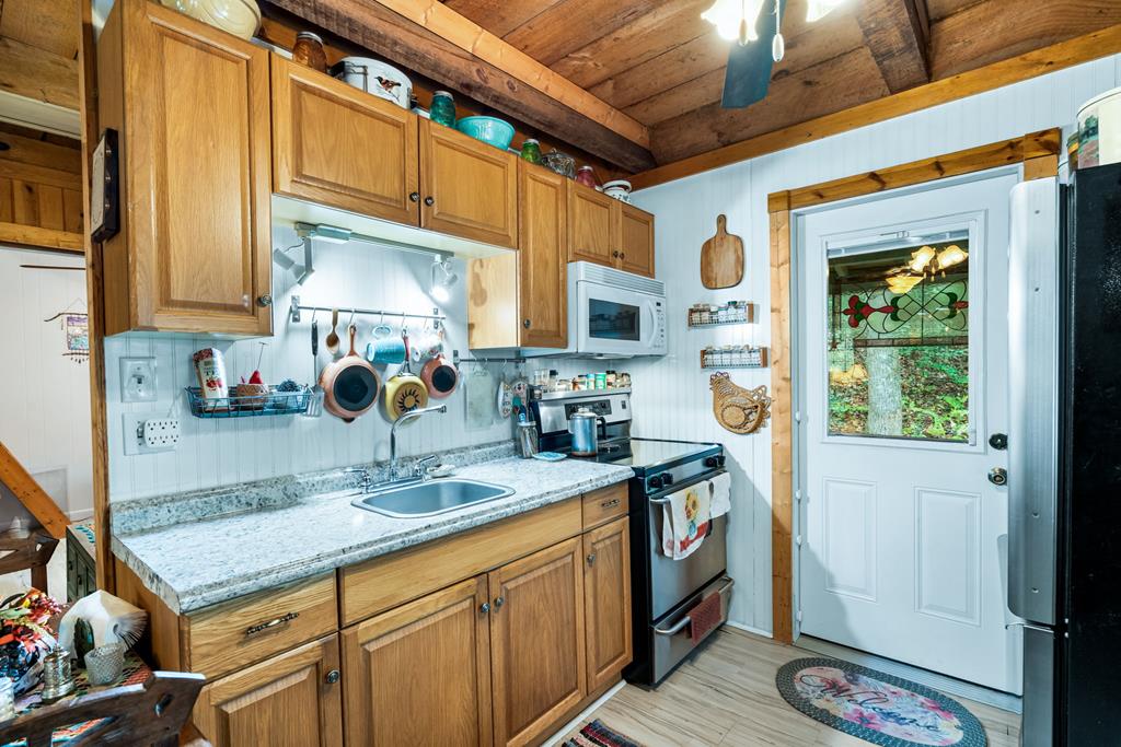 64 Timberline Road Murphy, NC 28906 - Photo 16 of 45 a kitchen with stainless steel appliances granite countertop a sink a stove and a refrigerator