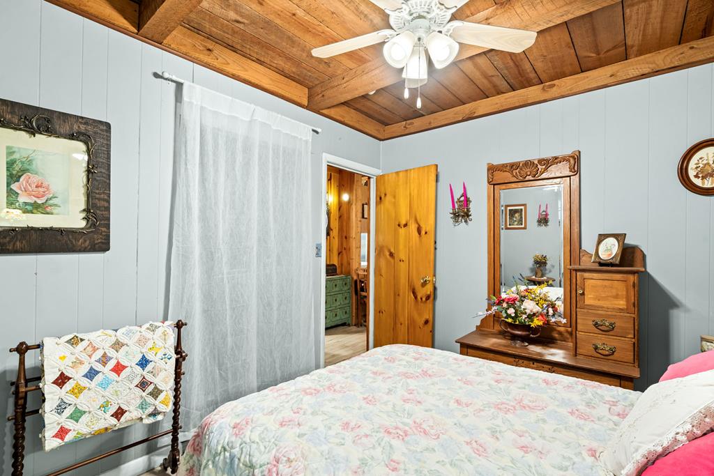 64 Timberline Road Murphy, NC 28906 - Photo 19 of 45 a bedroom with a bed and a chandelier