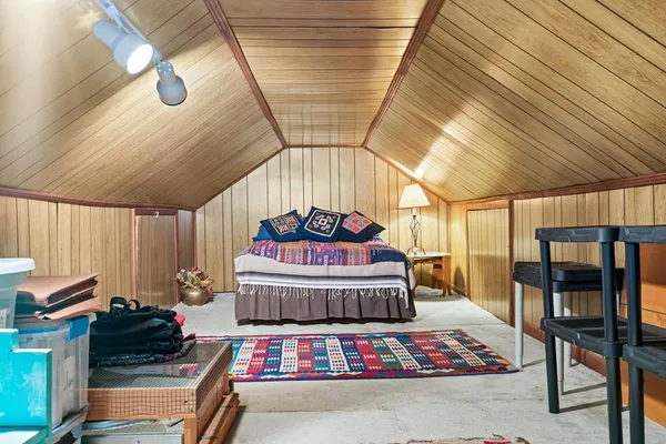 a bedroom with furniture and a chandelier