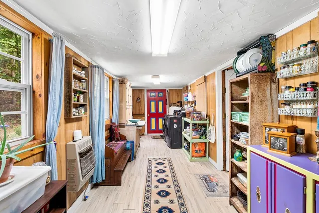 a hallway with a furniture and a book shelf