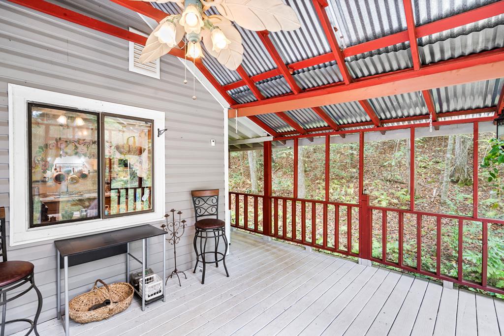 64 Timberline Road Murphy, NC 28906 - Photo 29 of 45 a view of a patio with table and chairs with wooden floor and fence