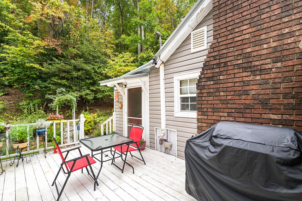 64 Timberline Road Murphy, NC 28906 - Photo 31 of 45 a view of a patio with table and chairs with wooden floor and fence