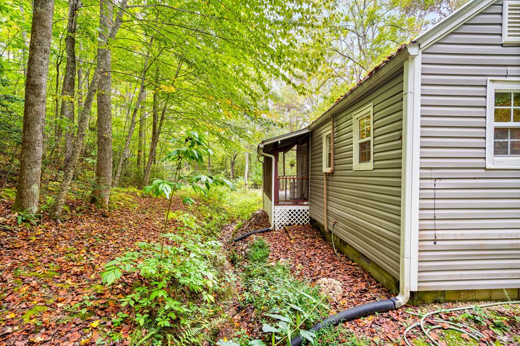 64 Timberline Road Murphy, NC 28906 - Photo 34 of 45 a yellow house with flower garden in front of it