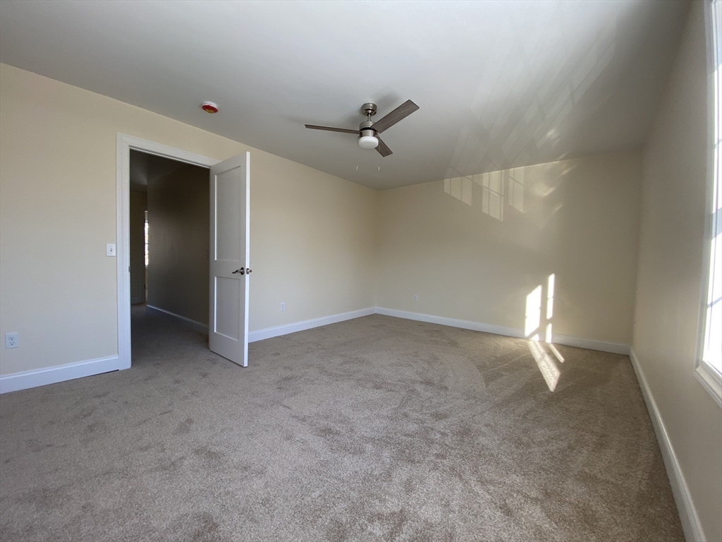 855 County Street, Unit 2 Attleboro, MA 02703 - Photo 13 of 27 an empty room with ceiling fan and window