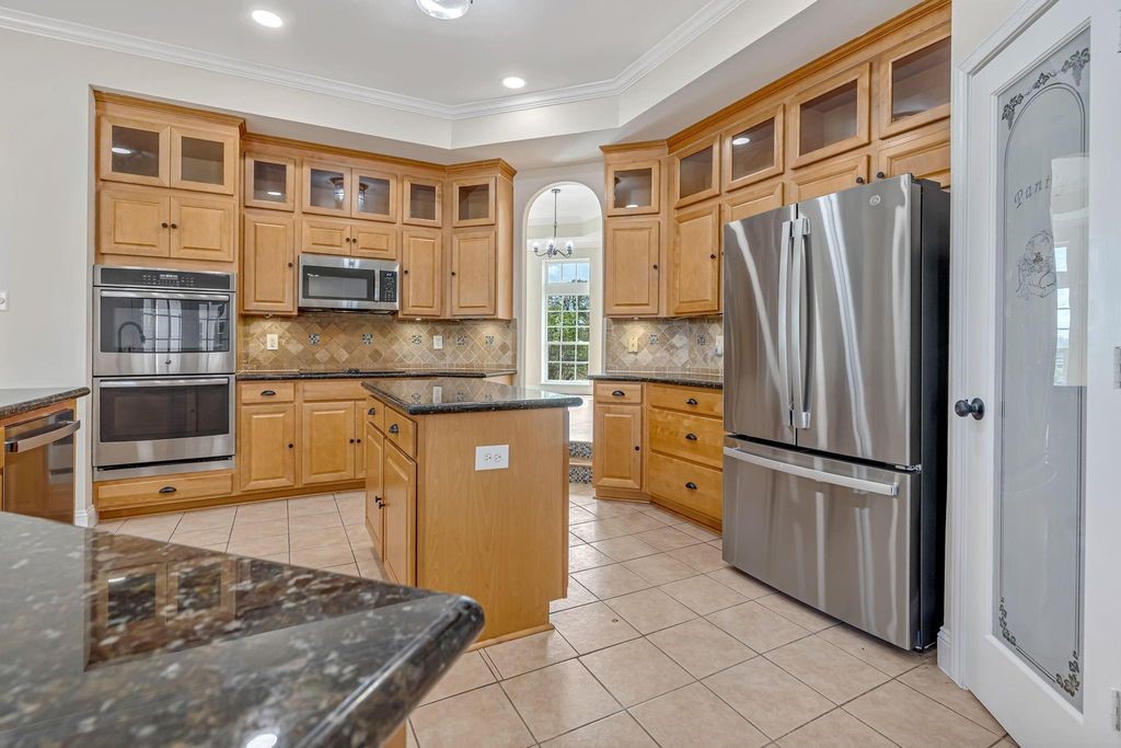 1810 McCrary Road Richmond, TX 77406 - Photo 9 of 25 a kitchen with stainless steel appliances granite countertop a refrigerator and a stove top oven