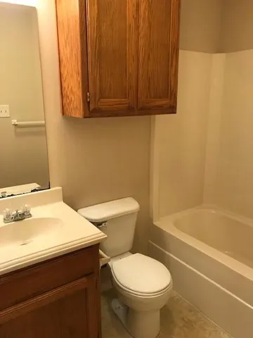 a bathroom with a sink a toilet and bathtub