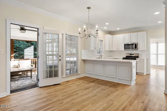 a view of a kitchen with wooden floor and windows