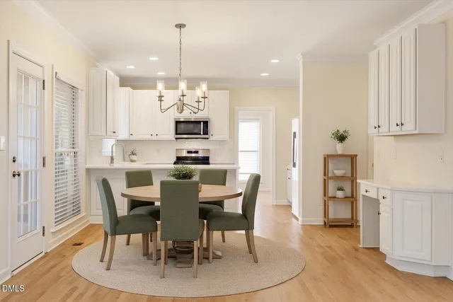 a large kitchen with cabinets wooden floor and stainless steel appliances