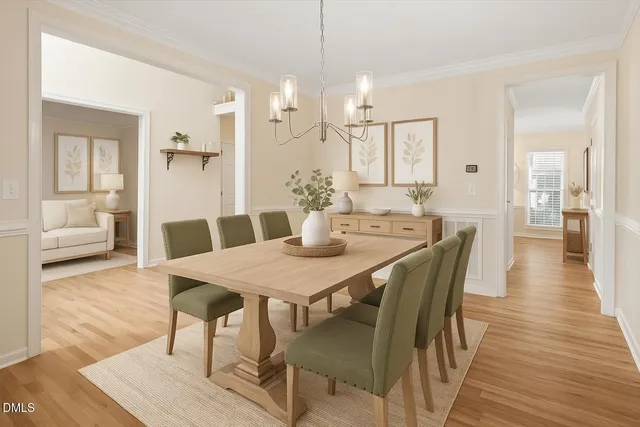 a view of a hallway with wooden floor and a bathroom