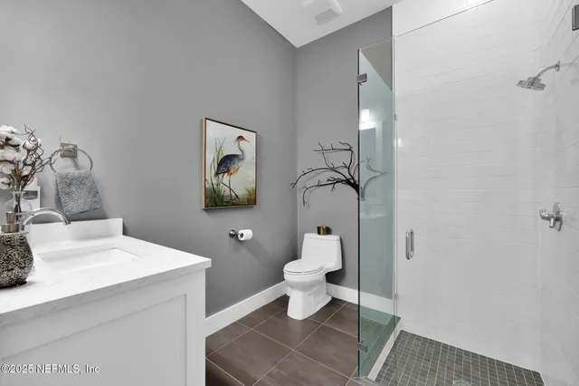 a bathroom with a sink toilet and a mirror