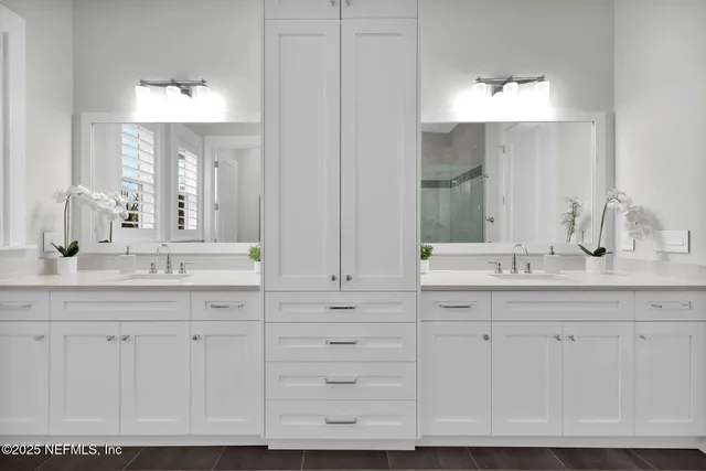 a bathroom with a sink vanity and mirror