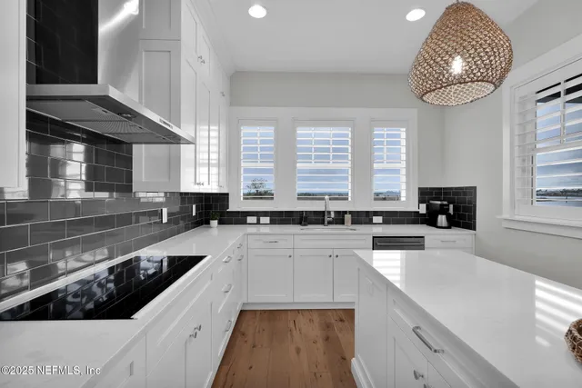 a large white kitchen with a large window