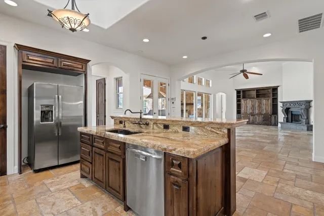 a kitchen with a counter space a sink appliances and cabinets