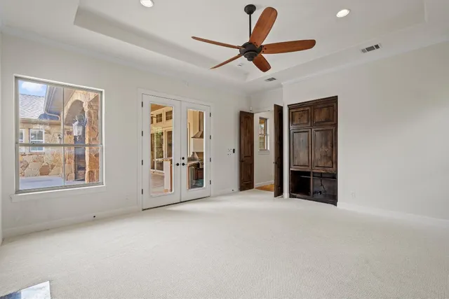 a view of a livingroom with a ceiling fan and window