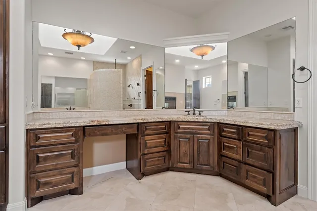 a large bathroom with a sink and a large mirror