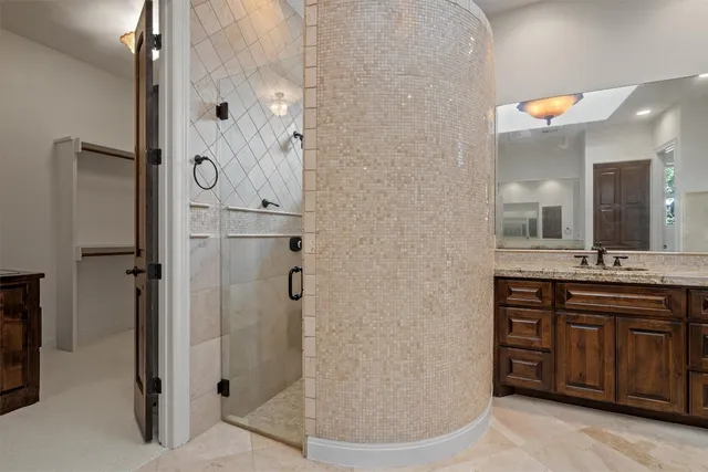 a bathroom with a double vanity sink a mirror and a shower