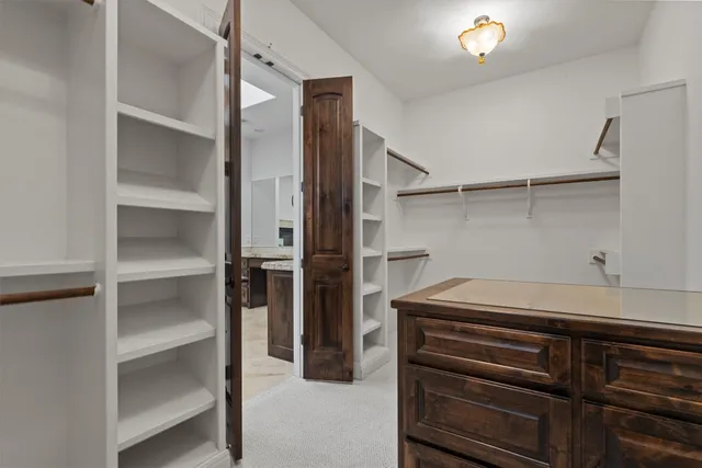 a bathroom with a granite countertop sink toilet and mirror