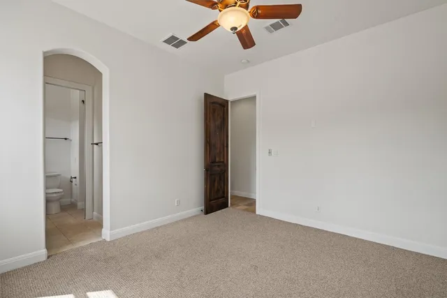 a bathroom with a granite countertop sink a toilet and a mirror