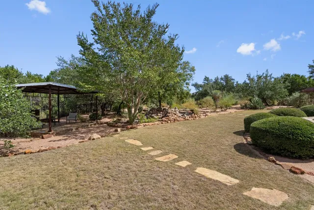 a view of table and chairs under an umbrella