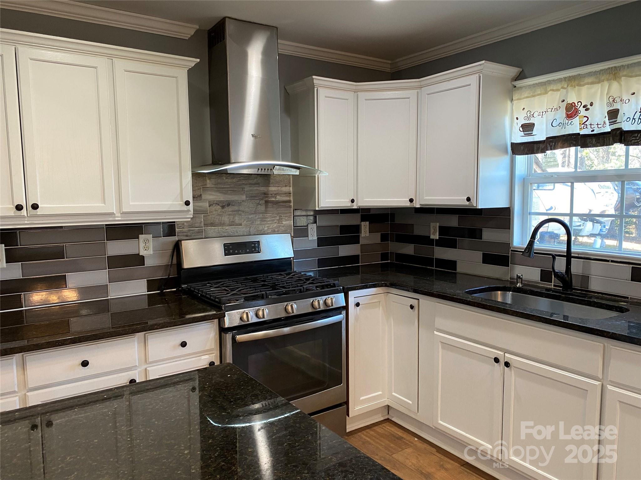 700 Colonial Avenue Gaffney, SC 29340 - Photo 4 of 9 a kitchen with stainless steel appliances granite countertop a stove a sink and white cabinets