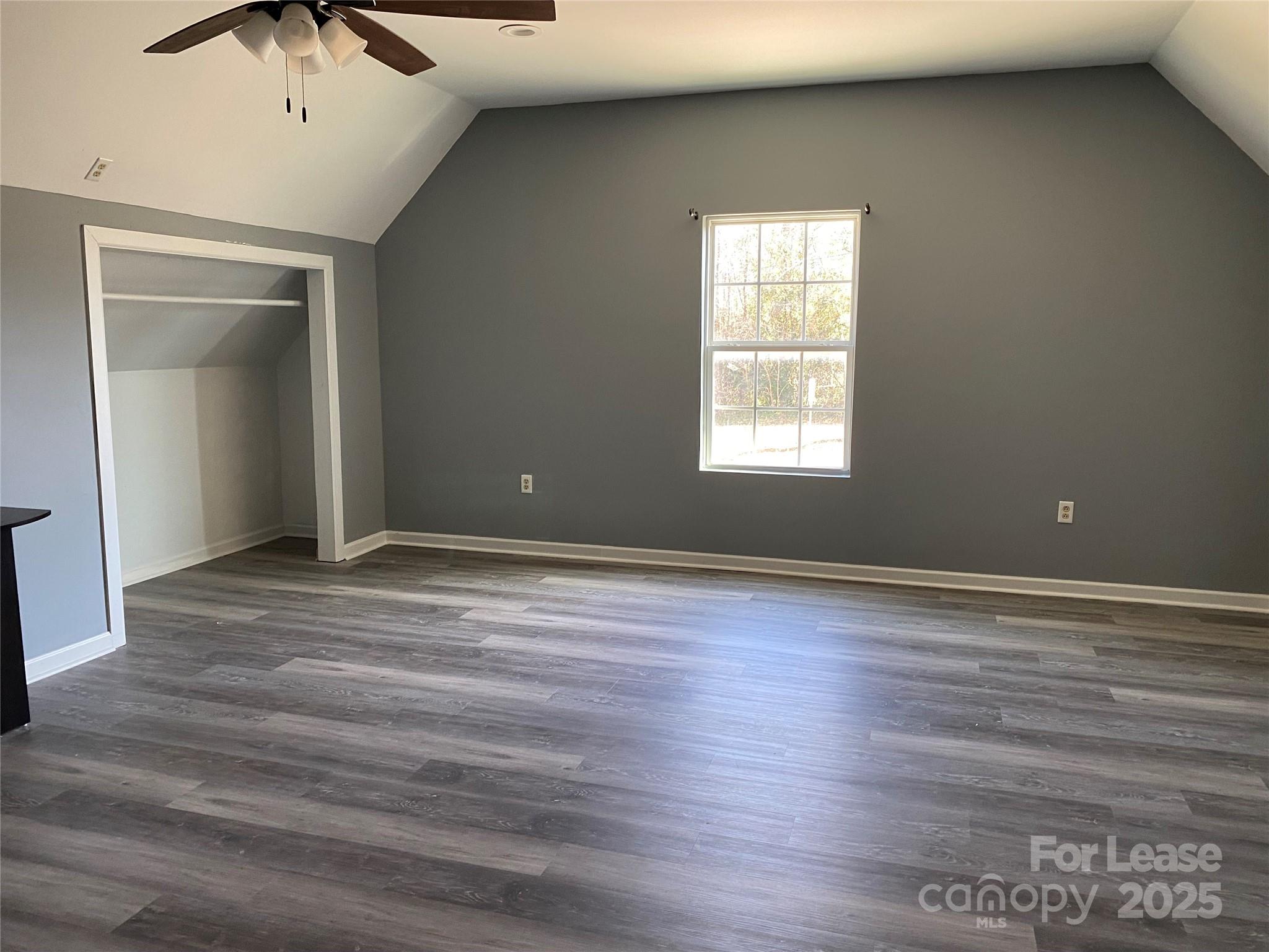 700 Colonial Avenue Gaffney, SC 29340 - Photo 7 of 9 an empty room with wooden floor and windows