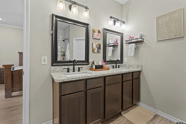 a bathroom with a double vanity sink and a mirror
