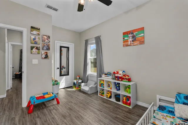a playing room with toys and a wooden floor