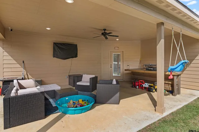 a living room with furniture a rug and a flat screen tv