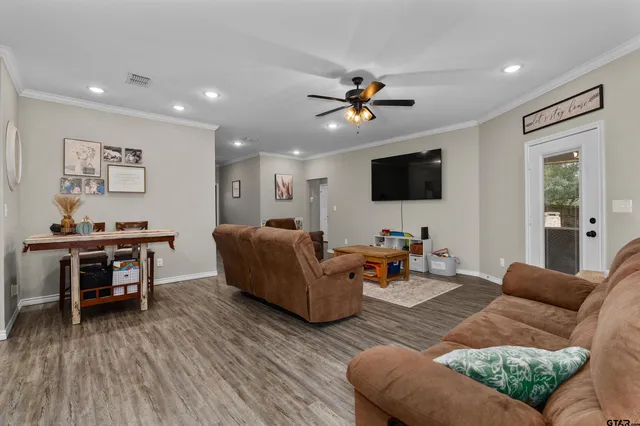 a living room with furniture and a flat screen tv