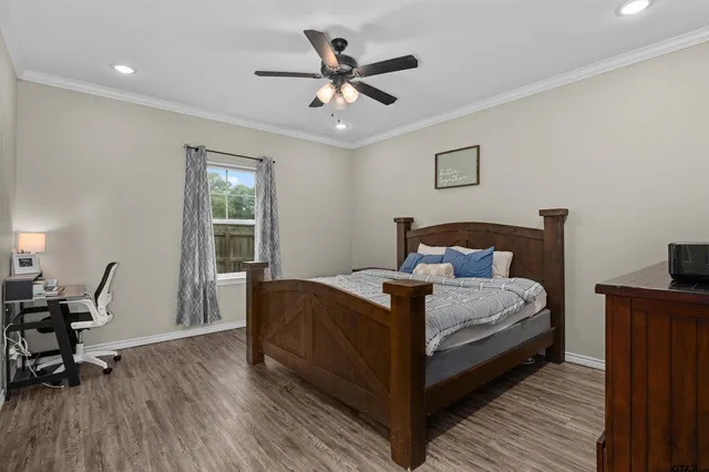 a bedroom with a bed and wooden floor