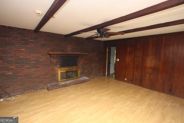 a view of an empty room with a fireplace