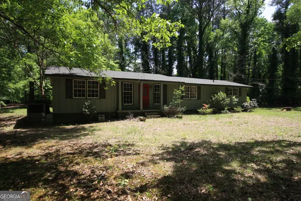 a front view of house with yard and green space