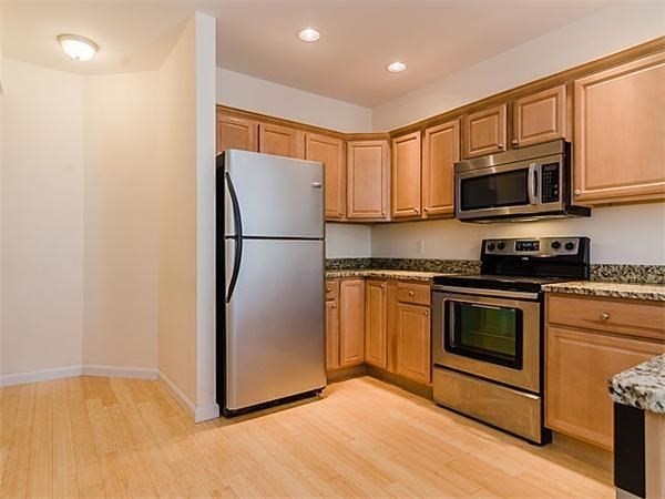 a kitchen with a refrigerator sink and microwave